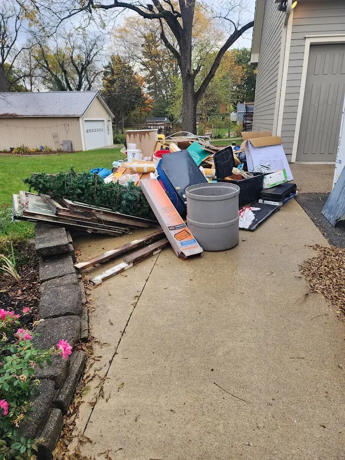 Dumpster being loaded with debris for Roofing Dumpster Rental in Palm Valley